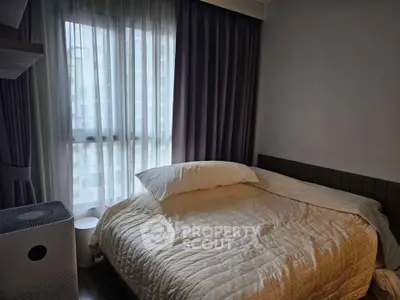 Cozy bedroom with soft lighting and modern decor, featuring a comfortable bed and stylish curtains.