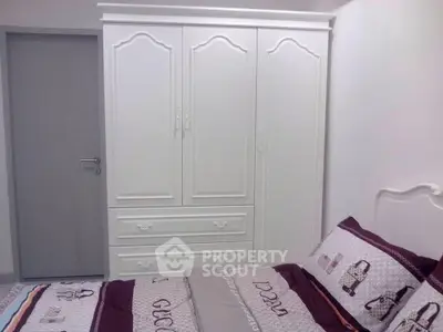 Cozy bedroom with elegant white wardrobe and stylish bedding