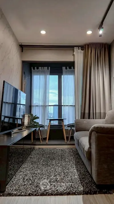 Cozy living room with modern decor and stunning city view through large window.