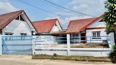 Charming suburban house with red-tiled roof and spacious front yard, perfect for family living.