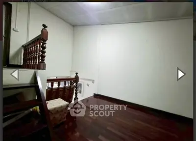 Spacious room with wooden flooring and unique railing design