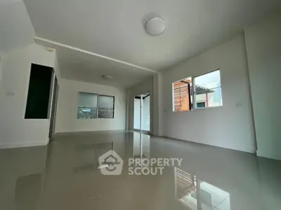 Spacious modern living room with glossy floors and large windows