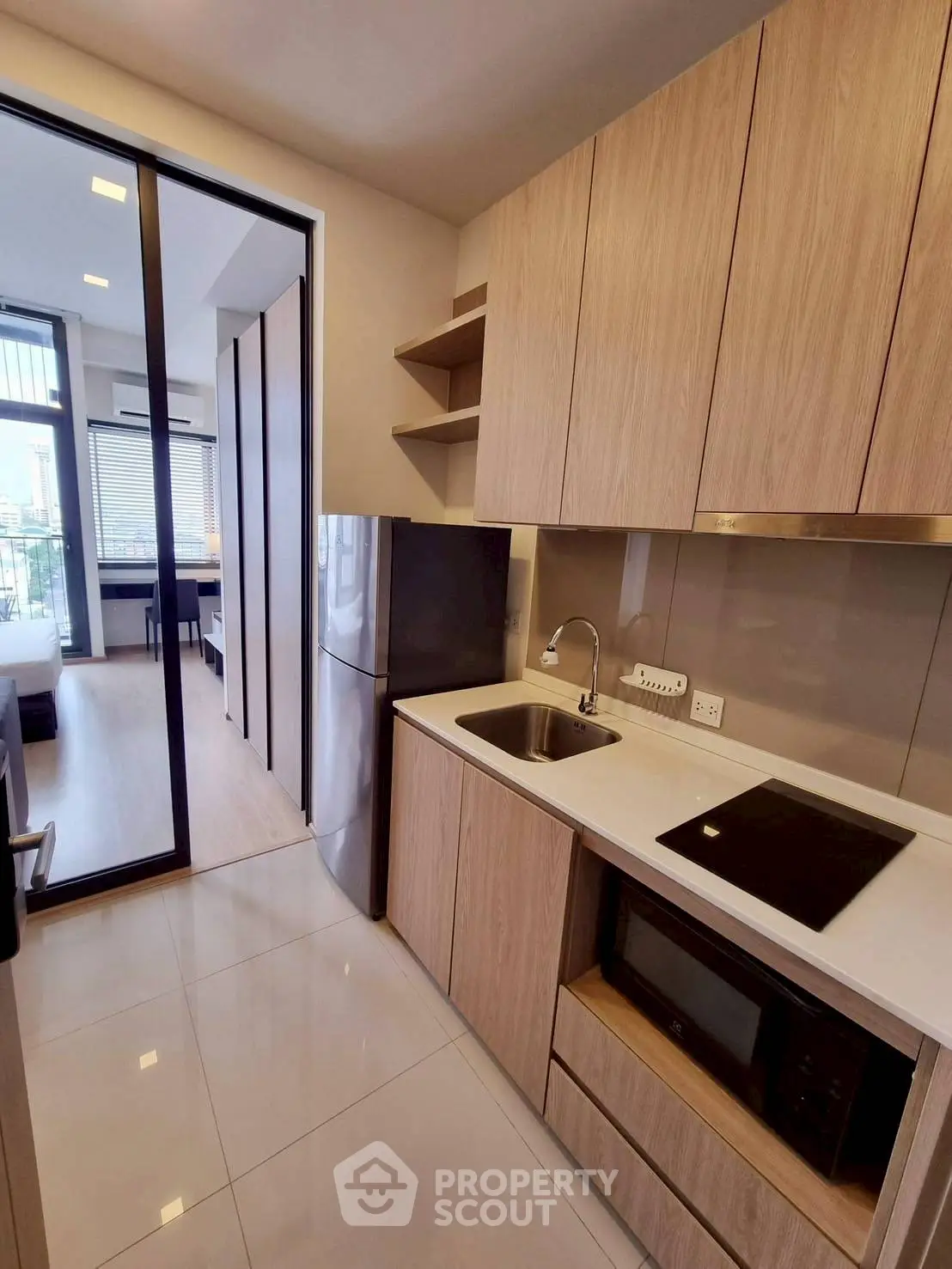 Modern kitchen with sleek cabinetry and appliances in a stylish apartment