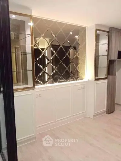 Elegant interior with mirrored wall and built-in shelving, perfect for modern living spaces.