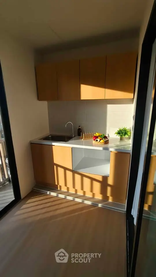 Modern kitchen with sleek cabinets and natural light, perfect for culinary enthusiasts.