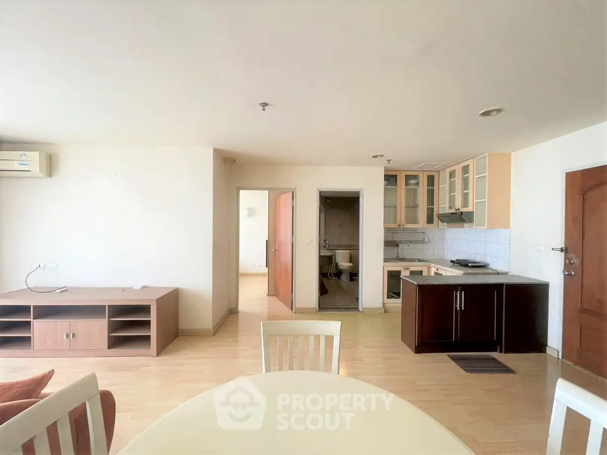 Spacious open-plan living and kitchen area with modern furnishings and ample natural light.
