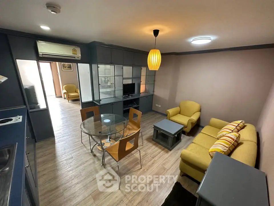 Modern living room with yellow sofas and glass dining table in stylish apartment