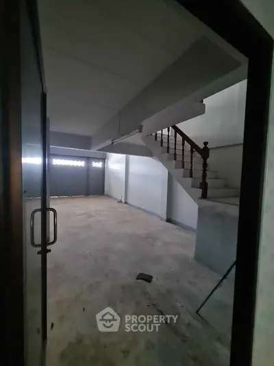 Spacious unfinished basement with staircase, ideal for customization and storage solutions.