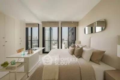 Luxurious bedroom with city view, elegant decor, and ample natural light in a high-rise apartment.