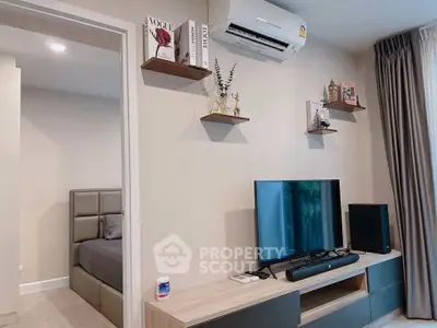 Modern living room with stylish decor and entertainment setup in a cozy apartment.