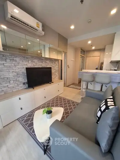 Modern living room with stylish decor and open kitchen layout in a cozy apartment.