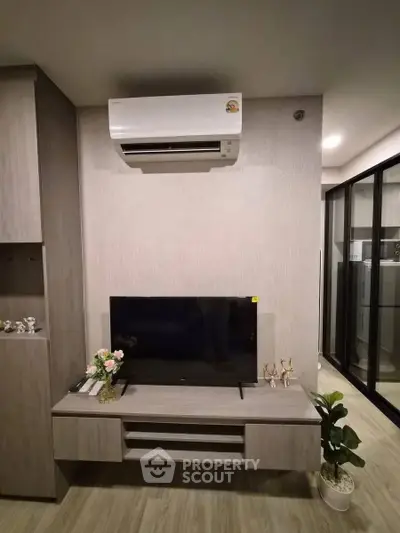 Modern living room with sleek TV unit and air conditioning, perfect for comfortable living.