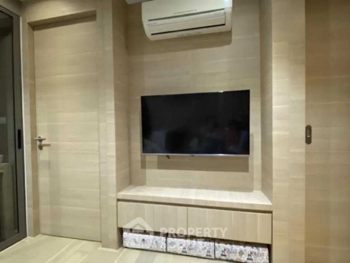 Modern living room with wall-mounted TV and air conditioning unit
