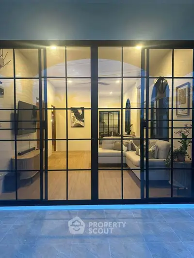 Elegant living room with modern decor and large glass doors, perfect for stylish urban living.