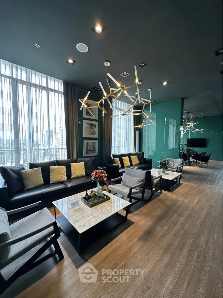 Luxurious modern living room with stylish lighting and floor-to-ceiling windows in high-rise building.