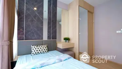 Modern bedroom with stylish decor and built-in wardrobe in a cozy apartment.