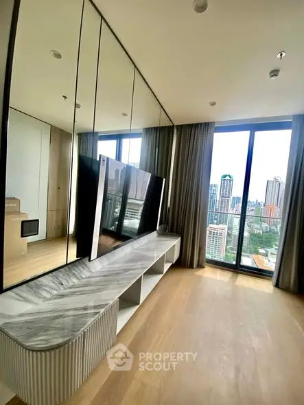Luxurious living room with floor-to-ceiling windows offering stunning city views