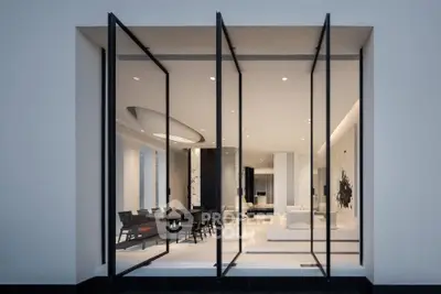 Luxurious modern living room with floor-to-ceiling glass doors and elegant interior design.