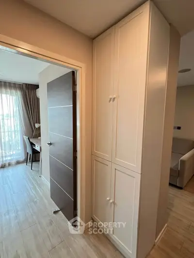 Modern apartment interior with wooden flooring and built-in storage cabinets