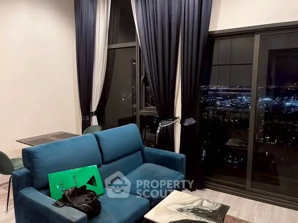 Stylish living room with city view, modern furniture, and elegant curtains.