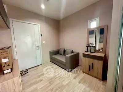 Cozy entryway with modern decor and compact sofa in stylish apartment.