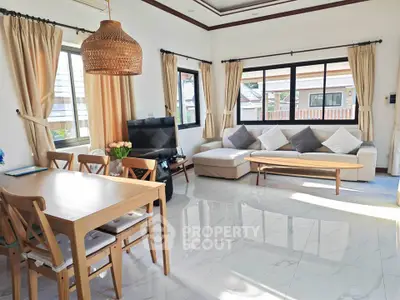 Bright and spacious living room with modern decor and large windows