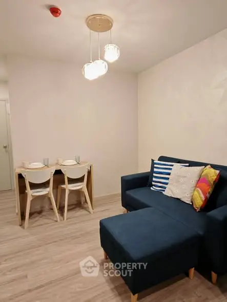 Modern living room with stylish furniture and cozy dining area, perfect for urban living.