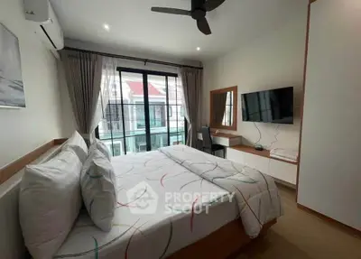 Modern bedroom with balcony access, featuring stylish decor and ample natural light.
