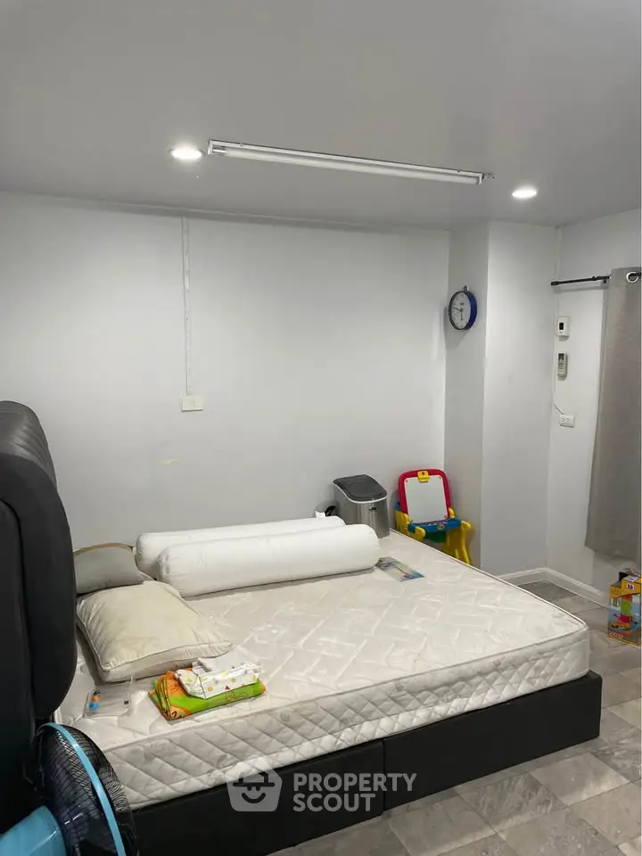 Cozy bedroom with minimalistic design and children's play area