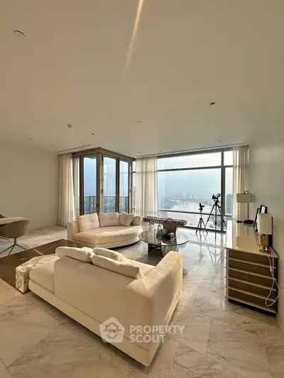 Luxurious living room with panoramic city views and elegant furnishings.