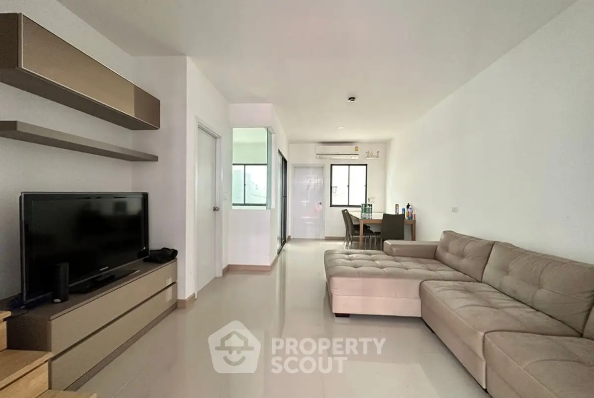 Spacious modern living room with sleek furniture and natural light