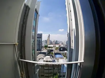 Stunning cityscape view from a high-rise balcony, showcasing urban skyline and modern architecture.