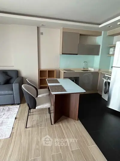 Modern apartment interior with compact kitchen and cozy living area