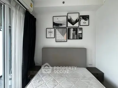 Modern bedroom with stylish wall art and large window for natural light