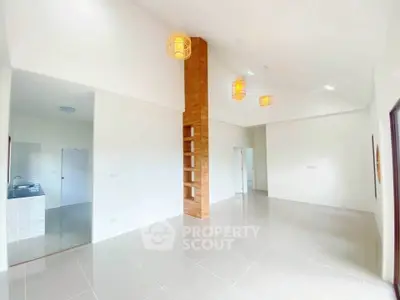 Spacious modern living room with high ceilings and elegant lighting