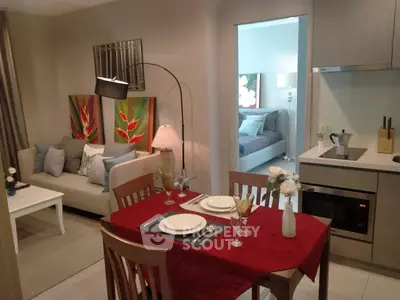 Modern open-plan living and dining area with stylish decor and cozy ambiance.