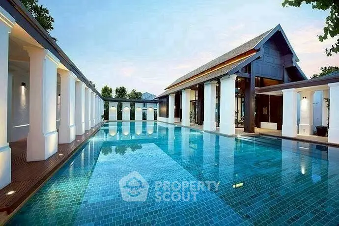 Luxurious poolside view of elegant property with classic architecture and serene ambiance.