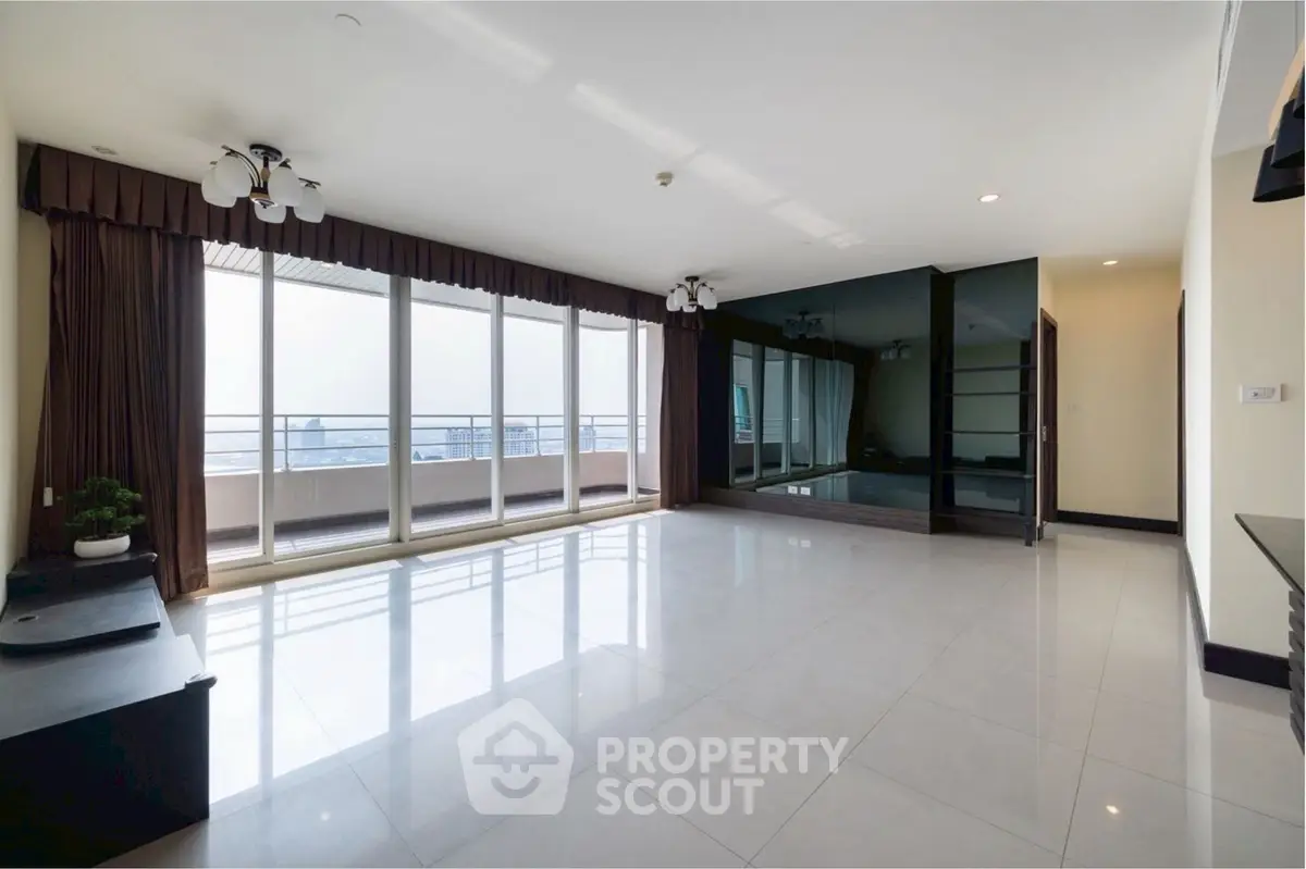 Spacious modern living room with large windows and balcony access