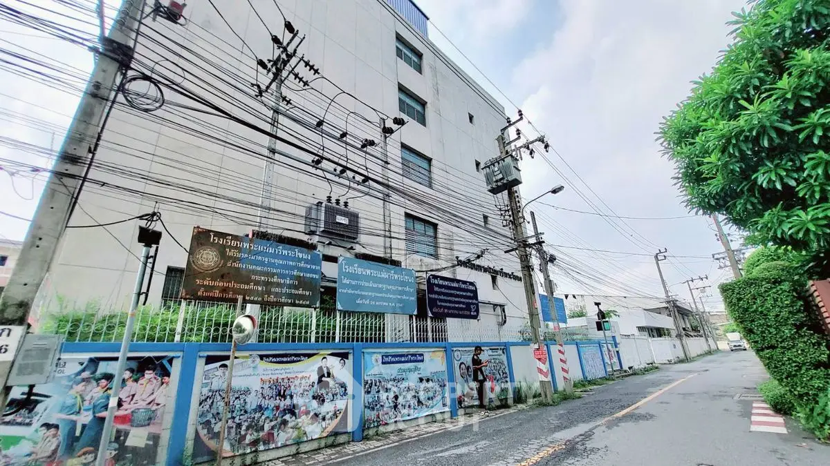 Urban building exterior with street view and power lines, showcasing city infrastructure.