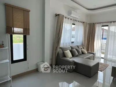 Spacious living room with modern sofa and large windows for natural light
