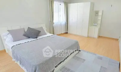 Spacious bedroom with modern decor and ample natural light
