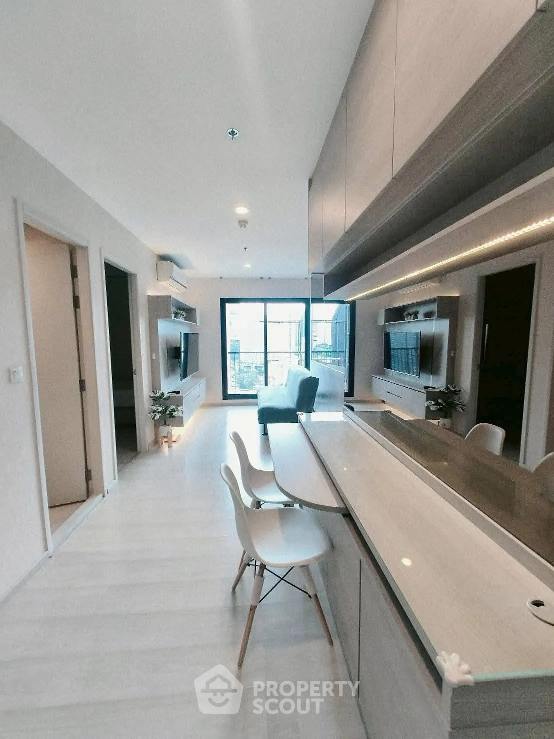 Modern open-plan living room with sleek kitchen and stylish decor