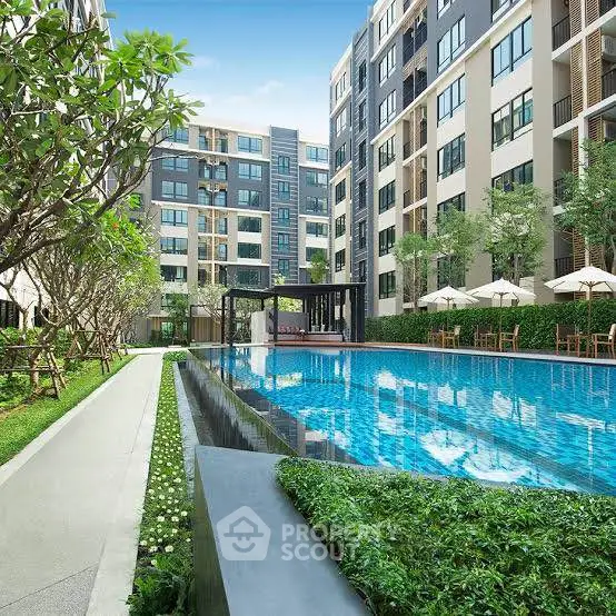 Luxurious apartment complex with a stunning outdoor pool and lush greenery.