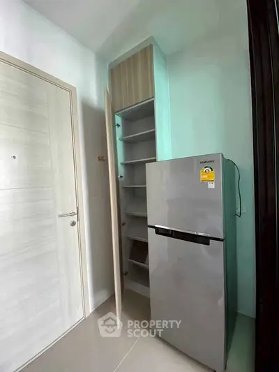 Modern kitchen with sleek fridge and ample storage space