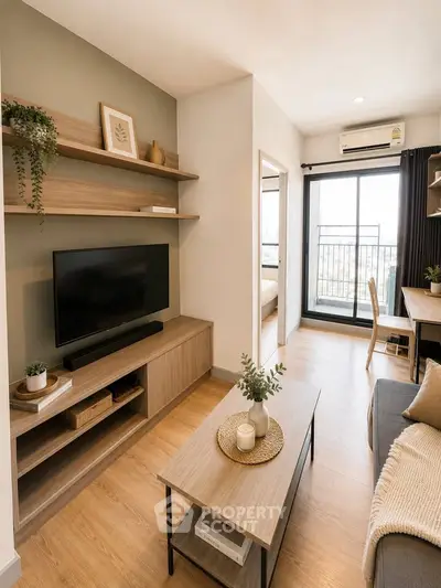 Modern living room with stylish decor and balcony view in a cozy apartment.