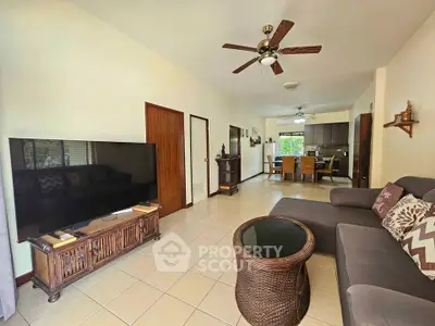 Spacious living room with modern decor and large TV in a cozy home