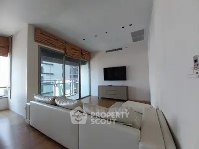 Spacious living room with modern decor and large windows offering a stunning view.
