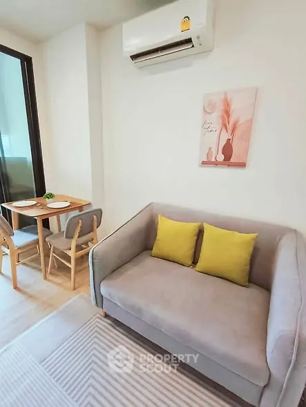 Cozy living room with modern decor and dining area, perfect for urban living.