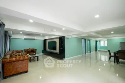 Spacious modern living room with elegant leather sofas and sleek entertainment center