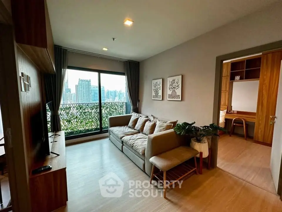 Modern living room with city view, cozy sofa, and stylish decor in a high-rise apartment.